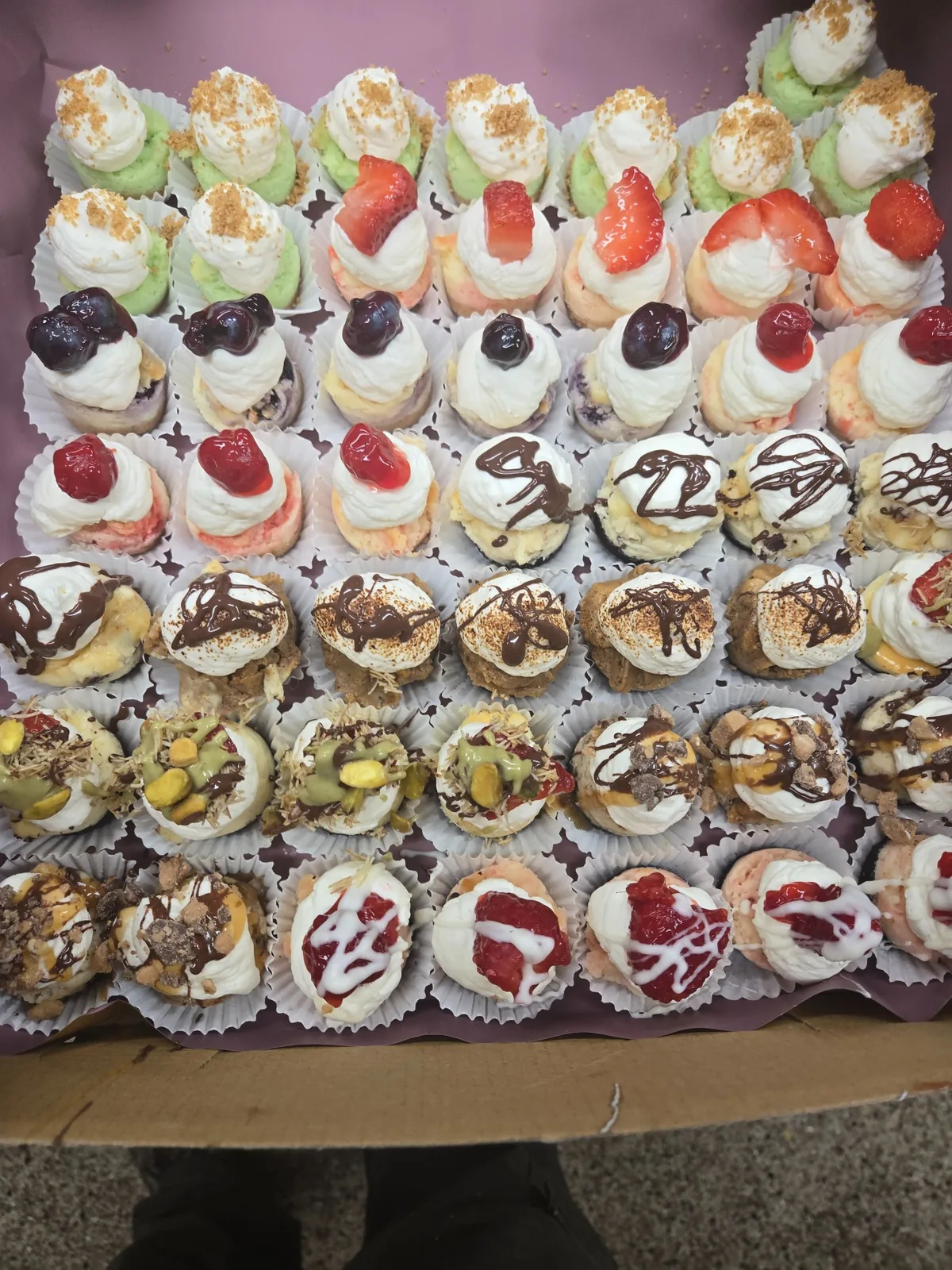 A large assortment of Josef's cheesecake cupcakes in many flavors